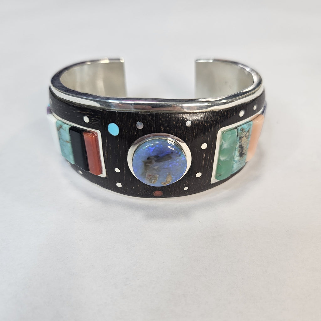 Multistone inlay cuff with central lapis cabochon and turquoise, coral, mother of pearl, and silver-dot constellation detail — Navajo handcrafted by Teddy